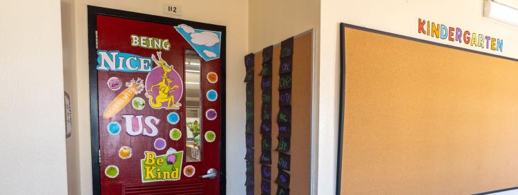 A colorful sign decorates a classroom door, creating a welcoming atmosphere for students.